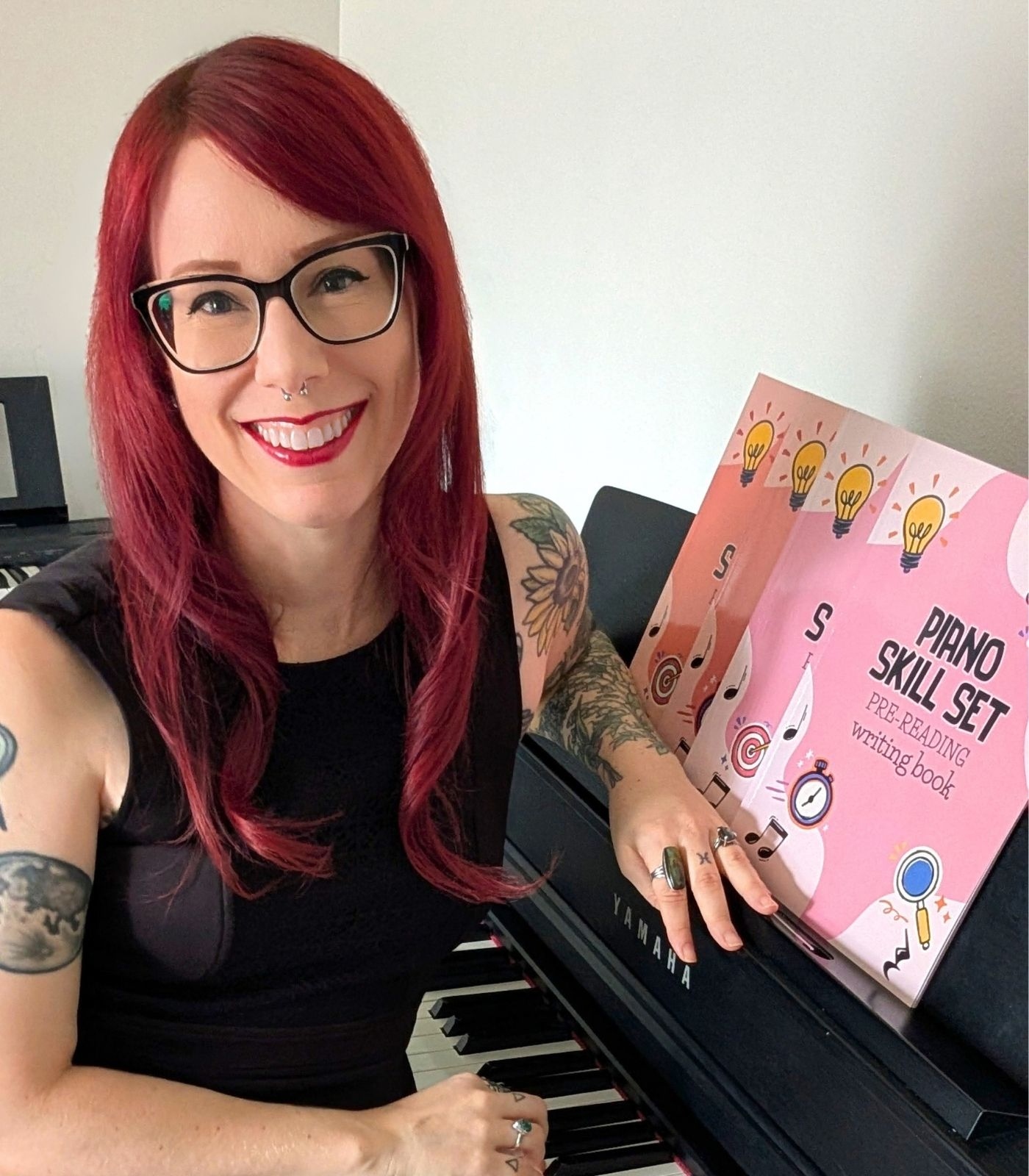 Phoenix, creator of Piano Skill Set, seated at her studio piano