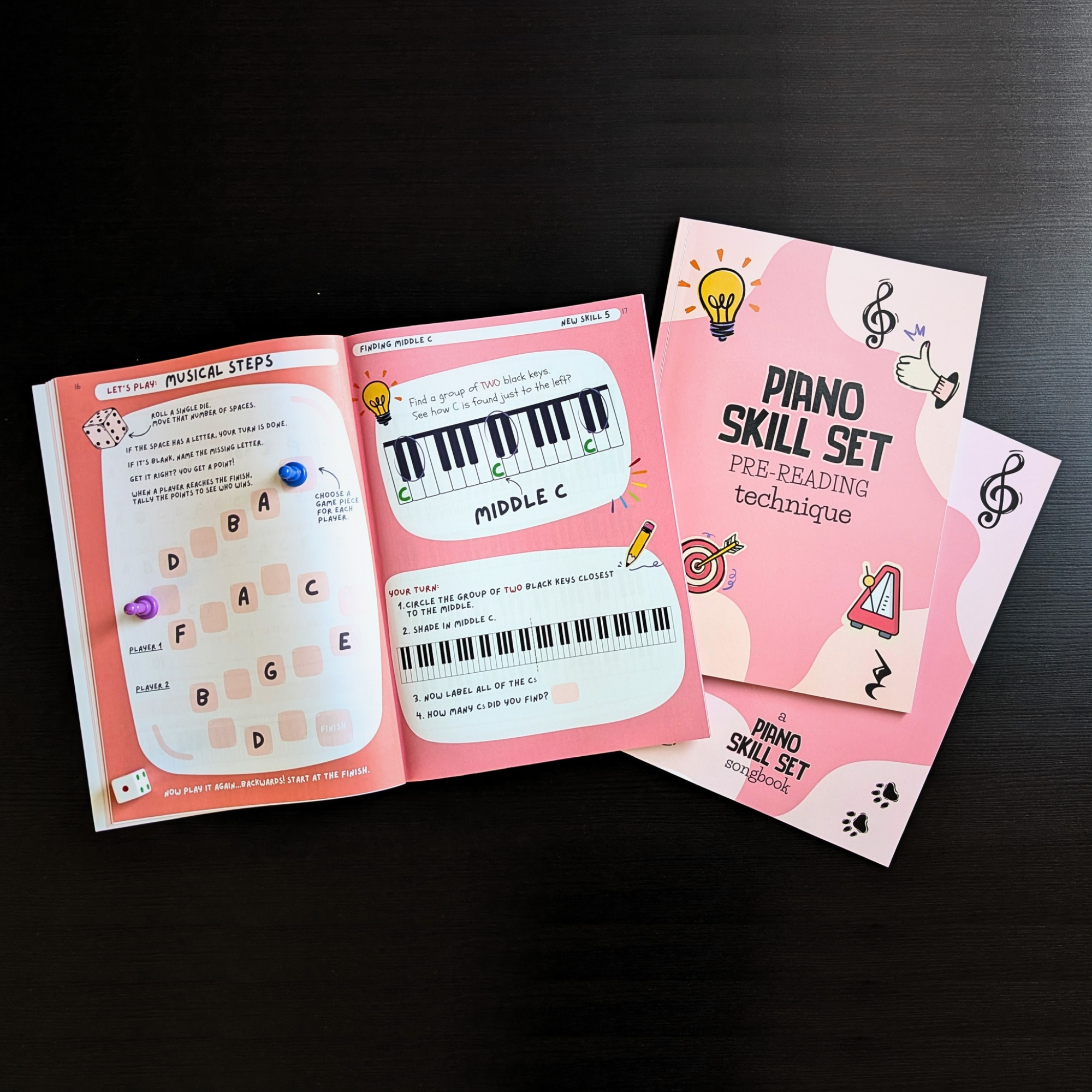 Piano Skill Set books on a black table